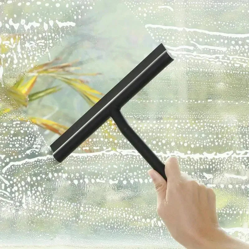 Black squeegee wiping glass